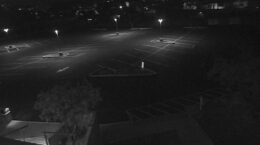 Security camera view of the UUCP parking lot at night, showing the new lights