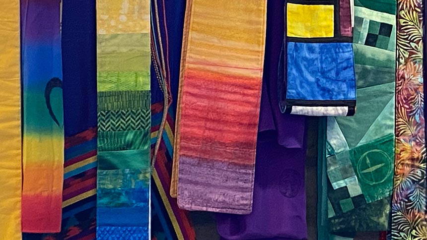 Closeup of colorful minister's stoles hanging on a wall