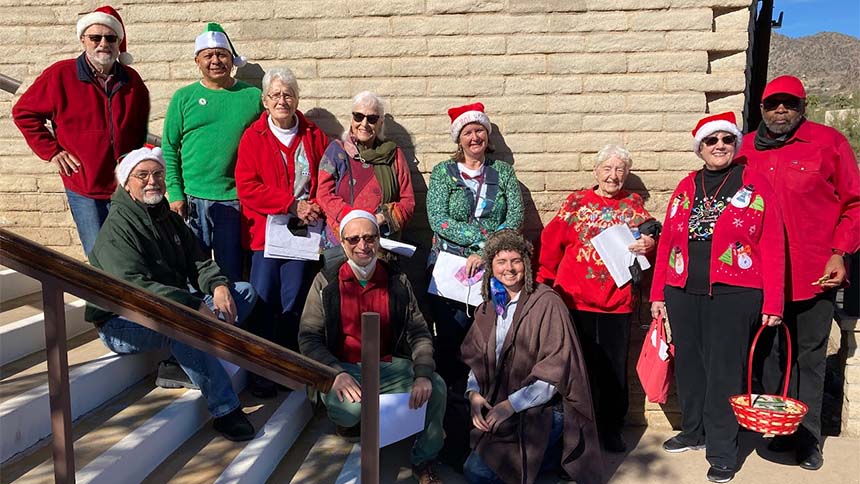 UUCP members in Christmas garb gathered on the UUCP steps prior to caroling