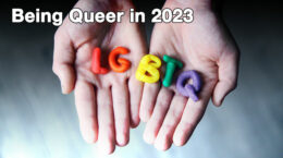 Hands outstretched with the letters LGBTQ on them in different colors